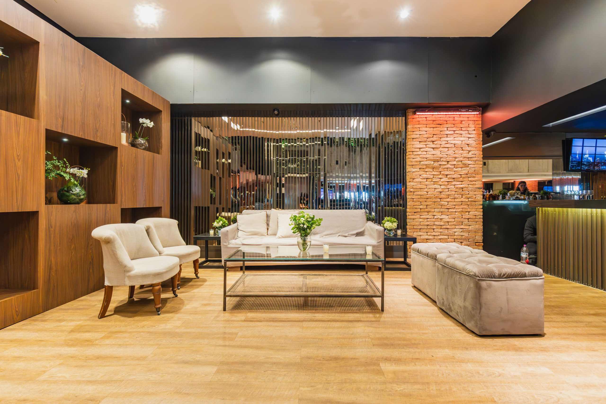 A stylishly lit modern living room featuring comfortable seating and elegant decor.